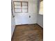 Small room with hardwood floors, window, and a door at 3816 W Dakota Ave, Denver, CO 80219