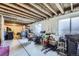 Unfinished basement area with exposed ceiling beams, concrete flooring, and a window for natural light at 20530 Randolph Pl, Denver, CO 80249