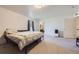 Large bedroom featuring carpeted floors, an ensuite bath, and natural light at 20530 Randolph Pl, Denver, CO 80249