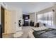 Bedroom featuring a window, modern black dresser and a gray bed with carpeted floor at 20530 Randolph Pl, Denver, CO 80249