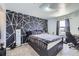 Bedroom with a modern accent wall, a window for natural light, and carpeted flooring at 20530 Randolph Pl, Denver, CO 80249