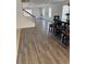 Open dining area with hardwood floors, a dark wood dining table with stools, and plentiful natural light at 20530 Randolph Pl, Denver, CO 80249