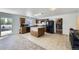 Spacious kitchen featuring stainless steel appliances, island, and tile floors at 20530 Randolph Pl, Denver, CO 80249