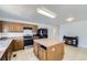 The kitchen has wood cabinets, tile floor, and a kitchen island at 20530 Randolph Pl, Denver, CO 80249
