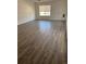 New flooring throughout the living room area with plenty of natural light from large window at 20530 Randolph Pl, Denver, CO 80249