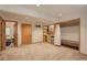 Spacious basement area featuring a wet bar with a mini-fridge, closet with bench seating, and neutral carpet at 1460 Quince Ave # 102, Boulder, CO 80304