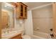Cozy full bathroom featuring a vanity, framed mirror, tub/shower combo, and wooden cabinetry at 1460 Quince Ave # 102, Boulder, CO 80304