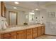 Well-lit bathroom with double sinks, vanity, and large mirror at 1460 Quince Ave # 102, Boulder, CO 80304