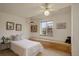 Cozy bedroom with a white twin bed, window seat, ceiling fan, and decorative artwork at 1460 Quince Ave # 102, Boulder, CO 80304