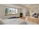 Bedroom featuring a large window, ceiling fan, neutral decor, and light hardwood floors at 1460 Quince Ave # 102, Boulder, CO 80304