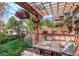Outdoor living space on deck with trellis, chairs, and lush landscaping at 1460 Quince Ave # 102, Boulder, CO 80304