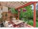 Cozy covered deck with dining table, chairs, and hanging flower baskets at 1460 Quince Ave # 102, Boulder, CO 80304
