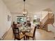 Inviting dining area with a round glass table, stylish chairs, and an open flow to the living space and staircase at 1460 Quince Ave # 102, Boulder, CO 80304