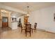 Bright dining area features a glass table, wood chairs, an elegant chandelier, and seamless access to the kitchen at 1460 Quince Ave # 102, Boulder, CO 80304