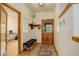 Welcoming entryway with tiled flooring, a bench, stylish decor, and a wooden door, creating a warm and inviting first impression at 1460 Quince Ave # 102, Boulder, CO 80304