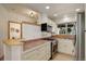 Well-lit kitchen with stainless steel appliances, ample counter space, and a convenient breakfast bar connecting to the dining area at 1460 Quince Ave # 102, Boulder, CO 80304