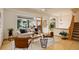 Cozy living room with natural light, modern decor, and an open staircase, blending comfort with contemporary design elements at 1460 Quince Ave # 102, Boulder, CO 80304