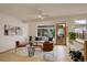 Sunlit living room boasts large windows, light wood floors, stylish furnishings, and indoor plants for a fresh and inviting feel at 1460 Quince Ave # 102, Boulder, CO 80304