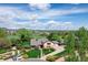 A beautiful home with large yard, lush greenery, and long driveway, aerial view at 10037 Allison Ct, Broomfield, CO 80021