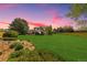 Large backyard at sunset, home in background at 10037 Allison Ct, Broomfield, CO 80021