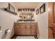 Bathroom with wood vanity, granite countertop, and a large mirror at 10037 Allison Ct, Broomfield, CO 80021