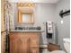 Basement bathroom with granite countertop and wood cabinets at 10037 Allison Ct, Broomfield, CO 80021