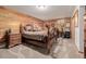 Cozy basement bedroom with wood-paneled walls and a comfortable wooden bed frame at 10037 Allison Ct, Broomfield, CO 80021