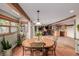 Open dining area with round table and chairs, offering views into the Gathering room at 10037 Allison Ct, Broomfield, CO 80021
