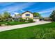 Beautiful home with a lush green lawn, mature trees, and a long driveway at 10037 Allison Ct, Broomfield, CO 80021