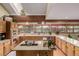 L-shaped kitchen with wood cabinets, granite island, and stainless steel appliances at 10037 Allison Ct, Broomfield, CO 80021