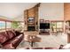 Spacious living room with a brick fireplace and leather furniture at 10037 Allison Ct, Broomfield, CO 80021