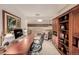 Home office with a large desk and built-in wooden bookcases at 10037 Allison Ct, Broomfield, CO 80021