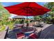 Large backyard patio with a red umbrella and plenty of seating at 10037 Allison Ct, Broomfield, CO 80021