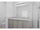 Bathroom featuring a double vanity, ample lighting, and a glass-enclosed shower at 1697 S Andes Way, Aurora, CO 80017