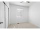 Bright bedroom featuring neutral carpet, a window with blinds, and a closet with sliding doors at 1697 S Andes Way, Aurora, CO 80017