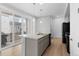 Well-lit kitchen with a center island and stainless steel appliances. Sliding glass door to patio at 1697 S Andes Way, Aurora, CO 80017