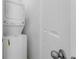 Efficient, stacked washer and dryer in a designated laundry area, next to entry door at 1697 S Andes Way, Aurora, CO 80017