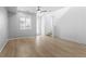 Airy living area with light wood floors, a modern ceiling fan and a large window for ample natural light at 1697 S Andes Way, Aurora, CO 80017