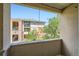 Balcony view of building with stone arches and stairs, many windows and trees at 8083 W 51St Pl # 203, Arvada, CO 80002