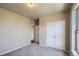 This neutral bedroom features grey carpet, a closet and a doorway to the bath at 8083 W 51St Pl # 203, Arvada, CO 80002