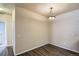 Light-filled dining area with modern light fixture and sleek wood floors at 8083 W 51St Pl # 203, Arvada, CO 80002