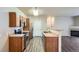Open kitchen with stainless steel appliances, and wood-look flooring that leads into the living area at 8083 W 51St Pl # 203, Arvada, CO 80002