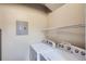 Laundry room with washer, dryer, wire shelving and fuse box at 8083 W 51St Pl # 203, Arvada, CO 80002