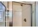 Bathroom shower with modern showerhead, glass doors and white subway tile at 8083 W 51St Pl # 203, Arvada, CO 80002