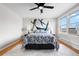 Comfortable bedroom featuring a patterned bedspread, two side lamps, and bright natural light creating a relaxing atmosphere at 6002 E 29Th Ave, Denver, CO 80207