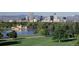 Scenic view of the city skyline across the water, surrounded by green trees and lawns at 6002 E 29Th Ave, Denver, CO 80207