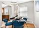 Cozy dining room with modern light fixture, hardwood floors, and blue chairs at 6002 E 29Th Ave, Denver, CO 80207