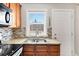 Updated kitchen with stainless steel sink, stylish backsplash, and modern appliances at 6002 E 29Th Ave, Denver, CO 80207