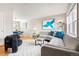 Bright living room with hardwood floors, gray sectional, and modern decor at 6002 E 29Th Ave, Denver, CO 80207