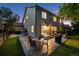 Backyard with patio featuring an outdoor dining area and seating at dusk at 13132 Pennsylvania Cir, Thornton, CO 80241